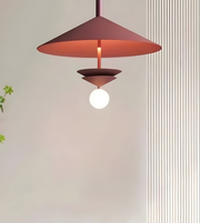 Modern pendant light with a red shade on a neutral background