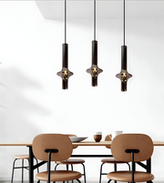 Modern dining area with pendant lights and a table.