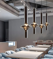 Modern interior design with pendant lights over a meeting room.