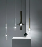 Modern pendant lights hanging against a gray background