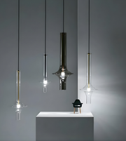Modern pendant lights hanging against a gray background