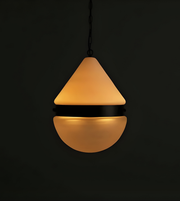 Pendant light with a conical shade on a black background