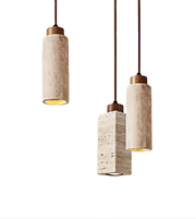 Three pendant lights with concrete-like cylindrical shades on a white background