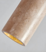 Cylindrical concrete light fixture with a warm glow on a gray background