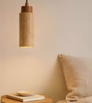 Pendant light fixture on a bedside table with a soft glow