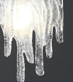 Close-up of a melting ice crystal against a dark background