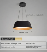 Black pendant light with adjustable line length on a gray background