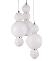 Modern pendant light with white glass spheres and gold accents on a white background