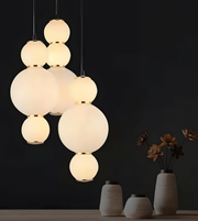 Modern chandelier with spherical glass lights on a dark background