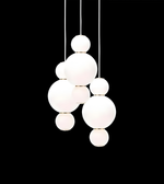 Modern pendant light with white glass spheres on a black background