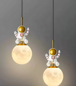 Two pendant lights with astronaut figures on a gray background