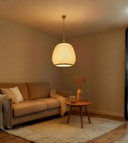 Living room with beige sofa, wooden side table, and pendant light.