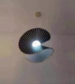 Modern pendant light with unique design on a neutral background