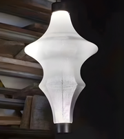 Modern pendant light with a unique geometric design in a dark room.