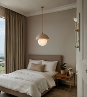 Modern bedroom with a bed, pendant light, and side table.