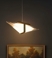 Modern pendant light fixture on a dark wall with a framed painting below.