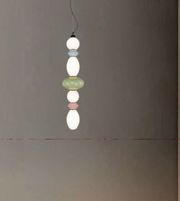 Pendant light with colorful beads on a plain background