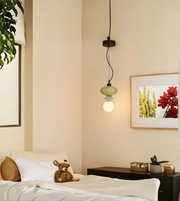Bedroom interior with a bed, lamp, and wall art.
