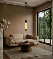 Modern living room with beige sofa, wooden coffee table, and pendant light.
