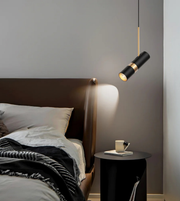 Modern bedroom with a bed, nightstand, and pendant light fixture.