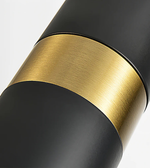 Close-up of a black and gold cylindrical object on a white background