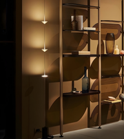 Modern shelving unit with decorative items against a patterned wall.