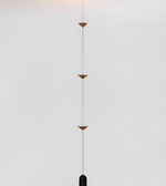 Modern pendant light with geometric design on a neutral background