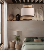Modern bedroom with a pendant light, bed, and decorative items.