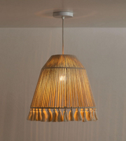 Woven pendant light with a beige shade on a plain background
