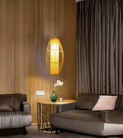Modern living room with a pendant light, sofa, and side table.