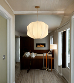 Modern pendant light hanging in a hallway with a bedroom in the background