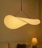 Modern pendant light hanging in a room with a warm glow