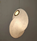 Modern pendant light with a unique design on a plain background