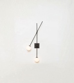 Sculptural wall sconce with angled arm and dual ambient light sources