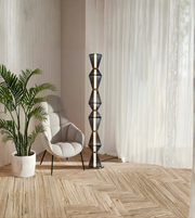 Modern sculptural metal floor lamp with geometric stacked design in living room