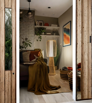 Natural bamboo slatted floor lamp styled in a cozy living room