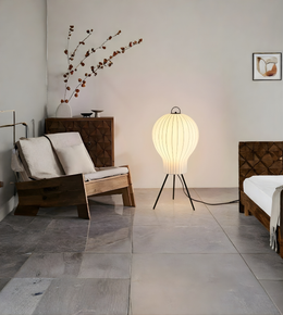 Japanese lantern style floor lamp illuminating a modern minimalist living room