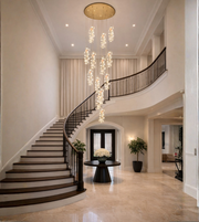 Luxury multi drop crystal pendant chandelier installed in a double height foyer and staircase