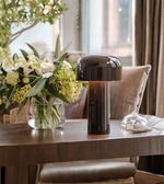 Black mushroom table lamp styled on wooden console table