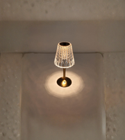 Vintage-style crystal touch table lamp glowing on tabletop