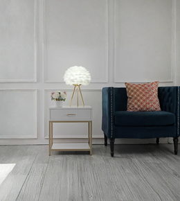Modern feather table lamp glowing softly in a living room setting