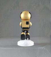 Gold astronaut figurine lamp holding glowing moon orb
