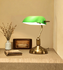 Banker desk lamp styled on table with books and decor