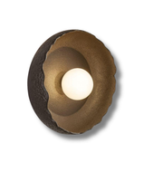 Decorative wall light fixture with a textured surface on a white background