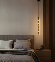 modern vertical pendant light with grid design hanging beside bed, warm ambient lighting for contemporary bedroom