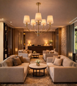 Linen fabric shade brass chandelier illuminating a luxury living room with warm ambient lighting