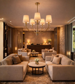 Linen fabric shade brass chandelier illuminating a luxury living room with warm ambient lighting