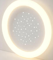 Round light fixture with a starry night design on a white background