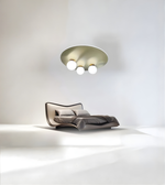 Minimalist bedroom featuring brass disc flush mount ceiling light with opal globe shades