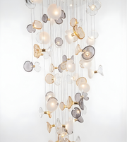 Decorative chandelier with glass and metal elements on a white background